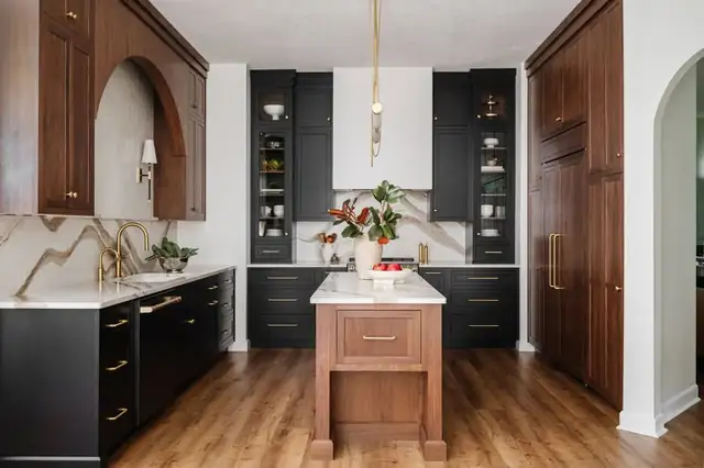 Moody Ponte Vedra kitchen with black inset cabinets, walnut accents, an arched wall niche and a walnut island