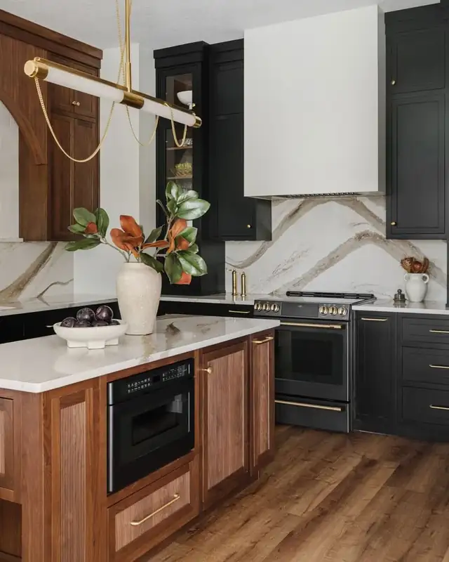 Ponte Vedra kitchen with black Shiloh inset cabinets, a reeded walnut island, arched details and gold-veined quartz