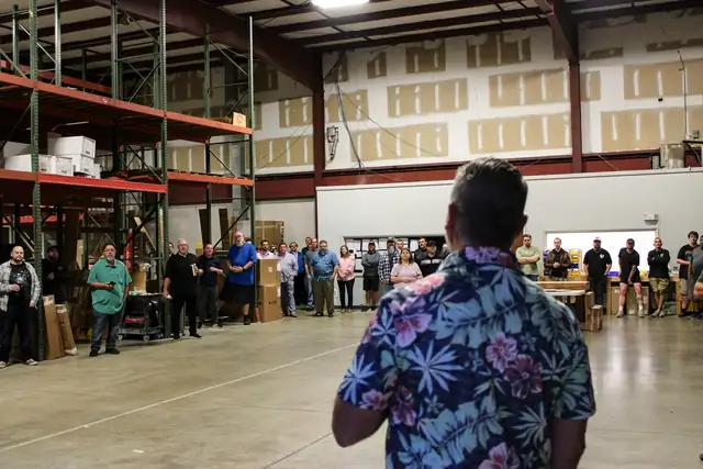 Woodsman Kitchens & Floors employee-owners gathered in the company's Jacksonville warehouse