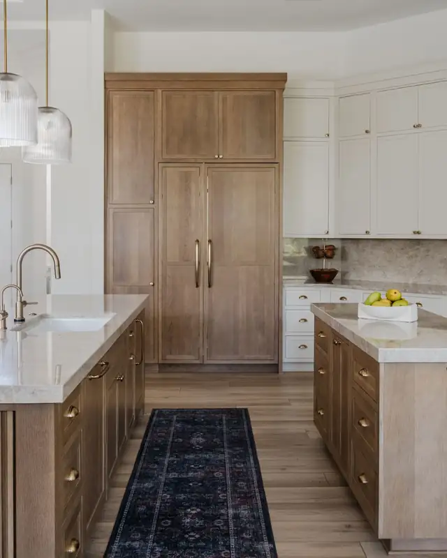 Warm transitional kitchen in Coastal Oaks with stained wood and eggshell painted cabinetry and a large island